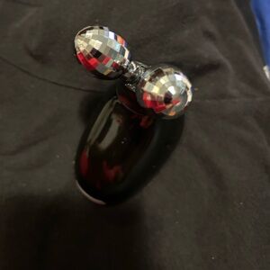 Microcurrent face massager complete with instruction book and charger.